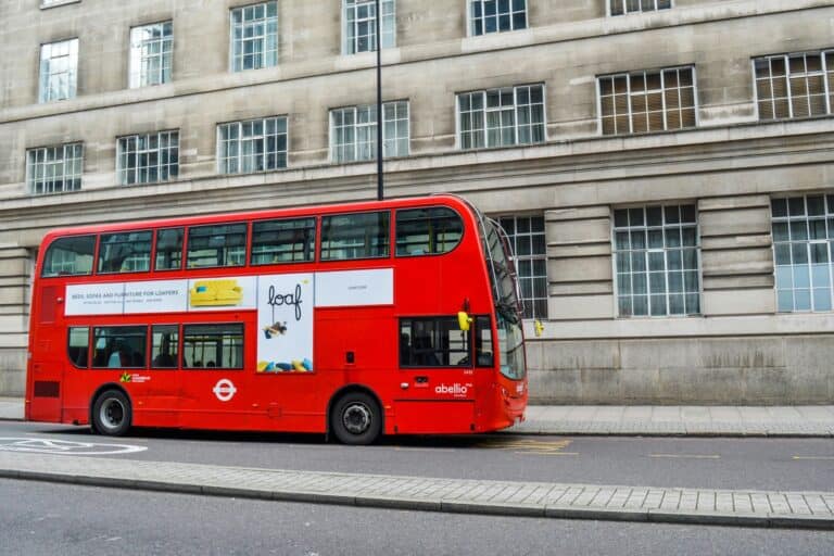 A double-decker dropping off passengers in the concept of 'how to use Romford's public transport'.