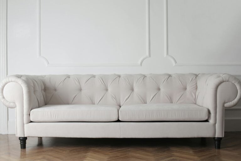 Off-white long and bulky sofa in the concept of 'how to move large furniture when moving house'.