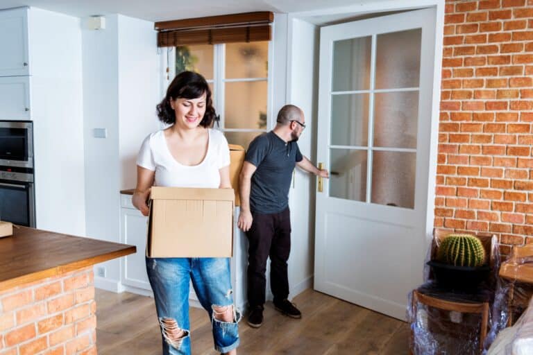 A couple arriving into their new home in the concept of 'differences between man and van services and traditional removals'.