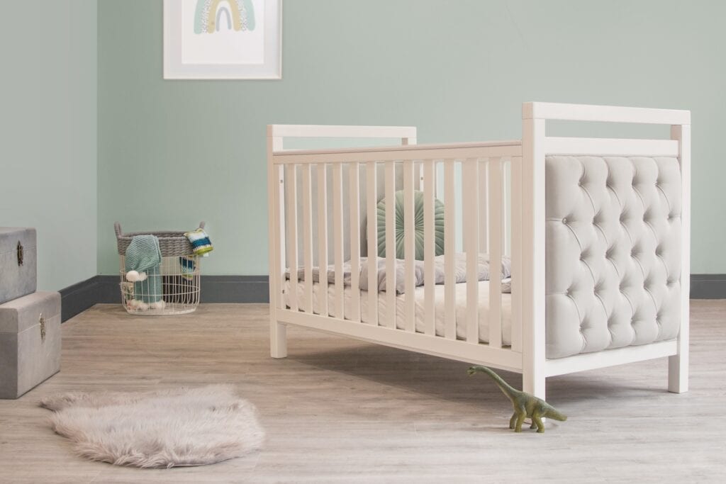 A baby cot in the middle of the room in the concept of 'What Types of Items Can Be Transported by a Man and Van Service?'