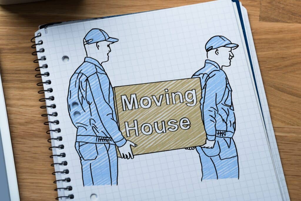 Moving crew carrying a box that says "Moving House" drawn on a notebook