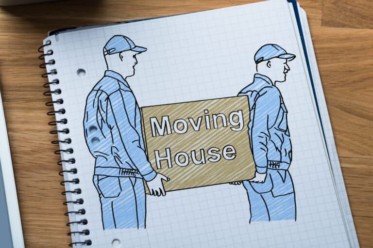 Moving crew carrying a box that says "Moving House" drawn on a notebook