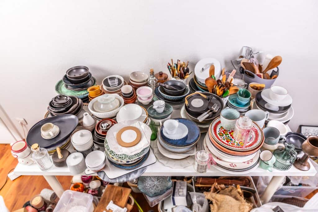 Utensils and kitchenware on top and under the table for decluttering